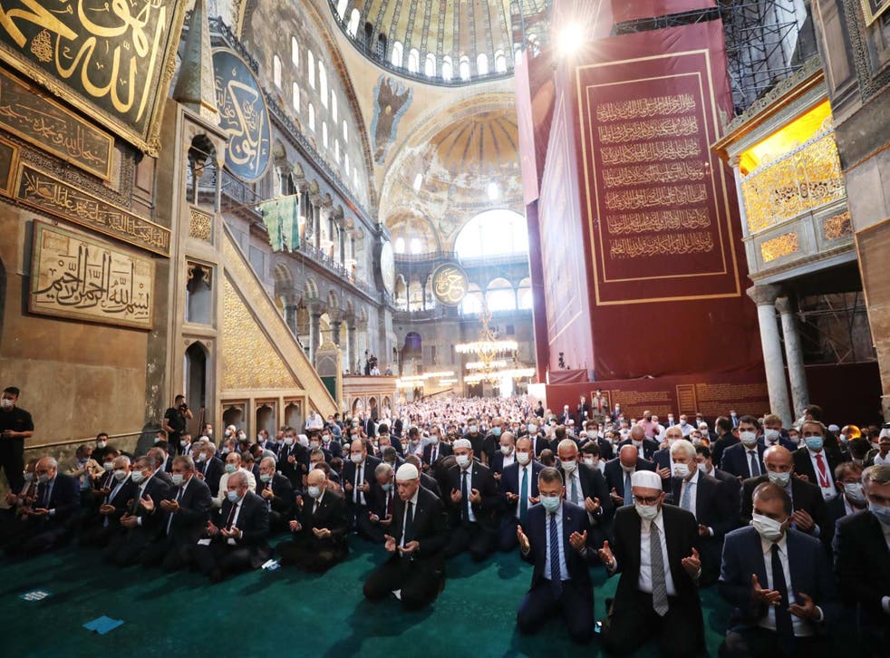 Recep Tayyip Erdogan, centre, and invited guests attend Friday prayers at Hagia Sophia