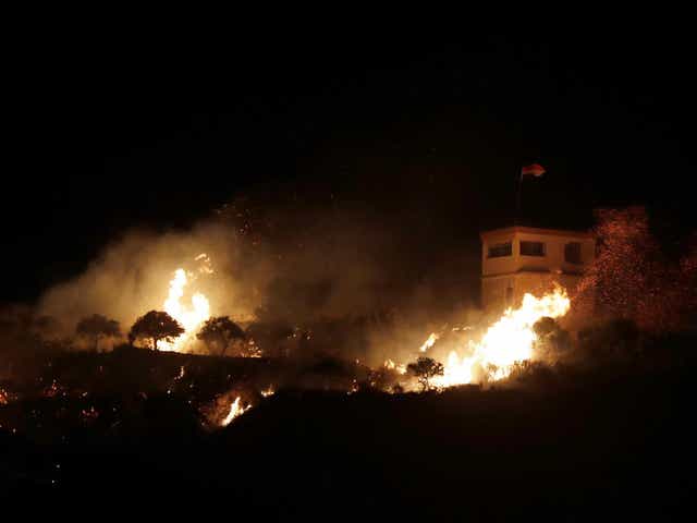 A fire following an Israeli helicopter attack on a Syrian observation post next to the village of Majdal Shams