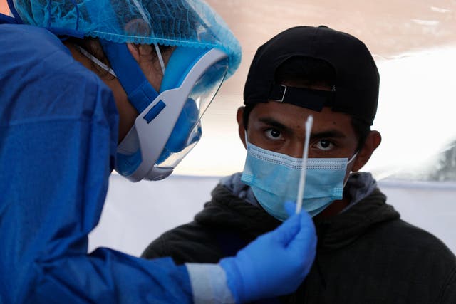 A doctor prepares to administer a nasal and throat swab to test for coronavirus in Mexico City