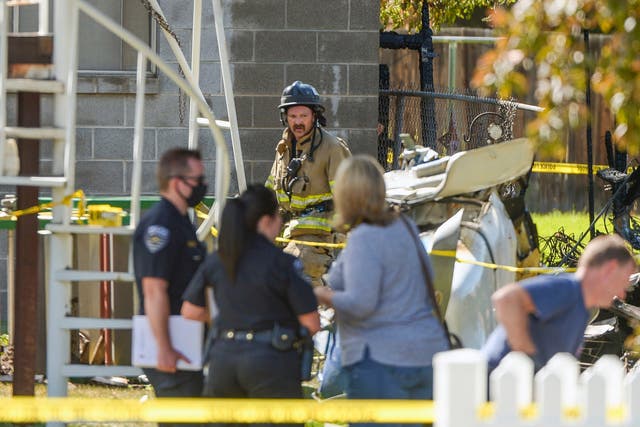 Emergency crews respond to a small plane crash in the back yard of a home in West Jordan, Utah
