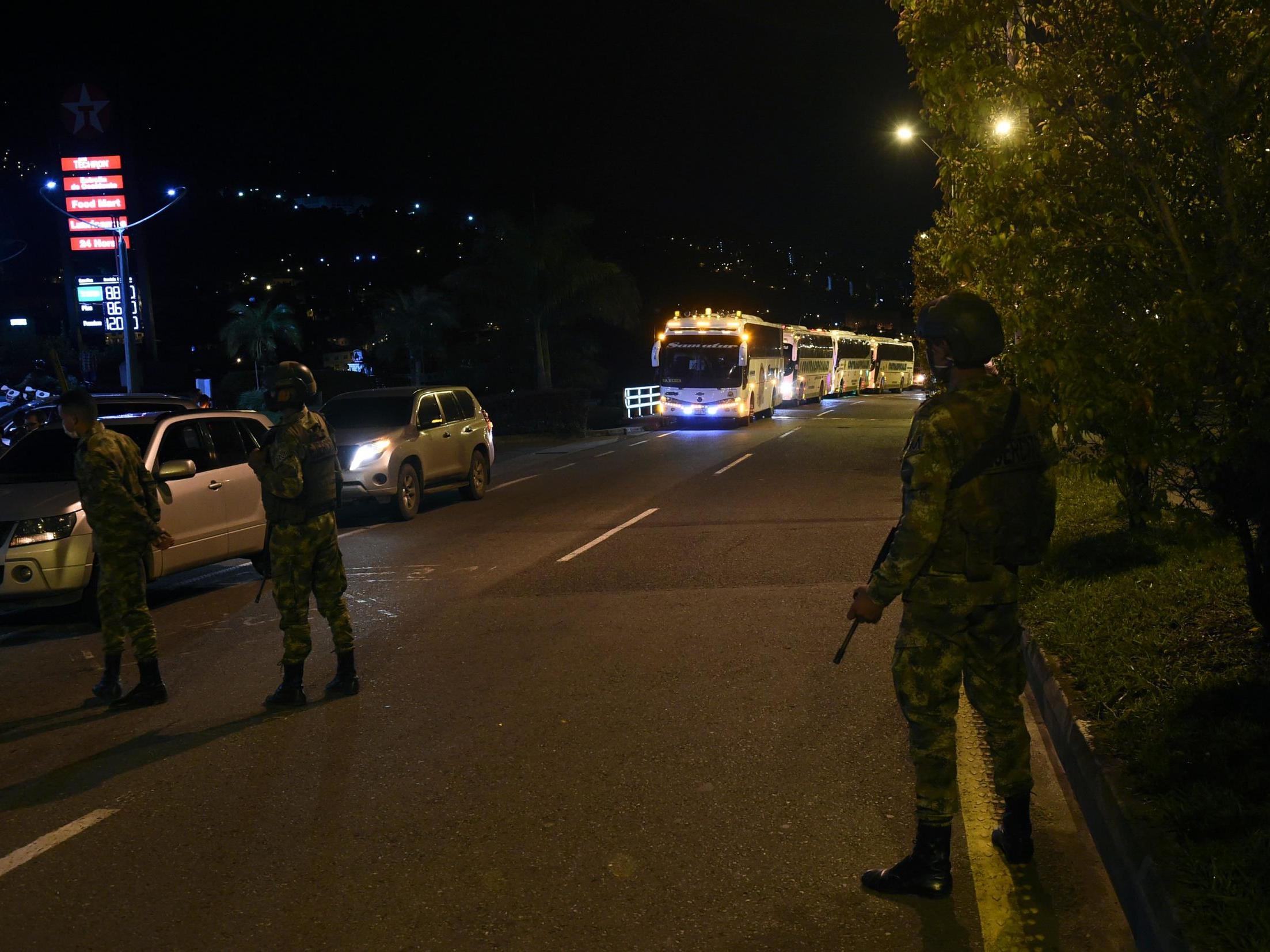 Colombians soldiers stand guard as the caravan carrying former FARC guerillas stopped at a gas station while heading to Mutata, Antioquia department, Colombia