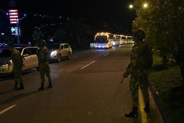 Colombians soldiers stand guard as the caravan carrying former FARC guerillas stopped at a gas station while heading to Mutata, Antioquia department, Colombia