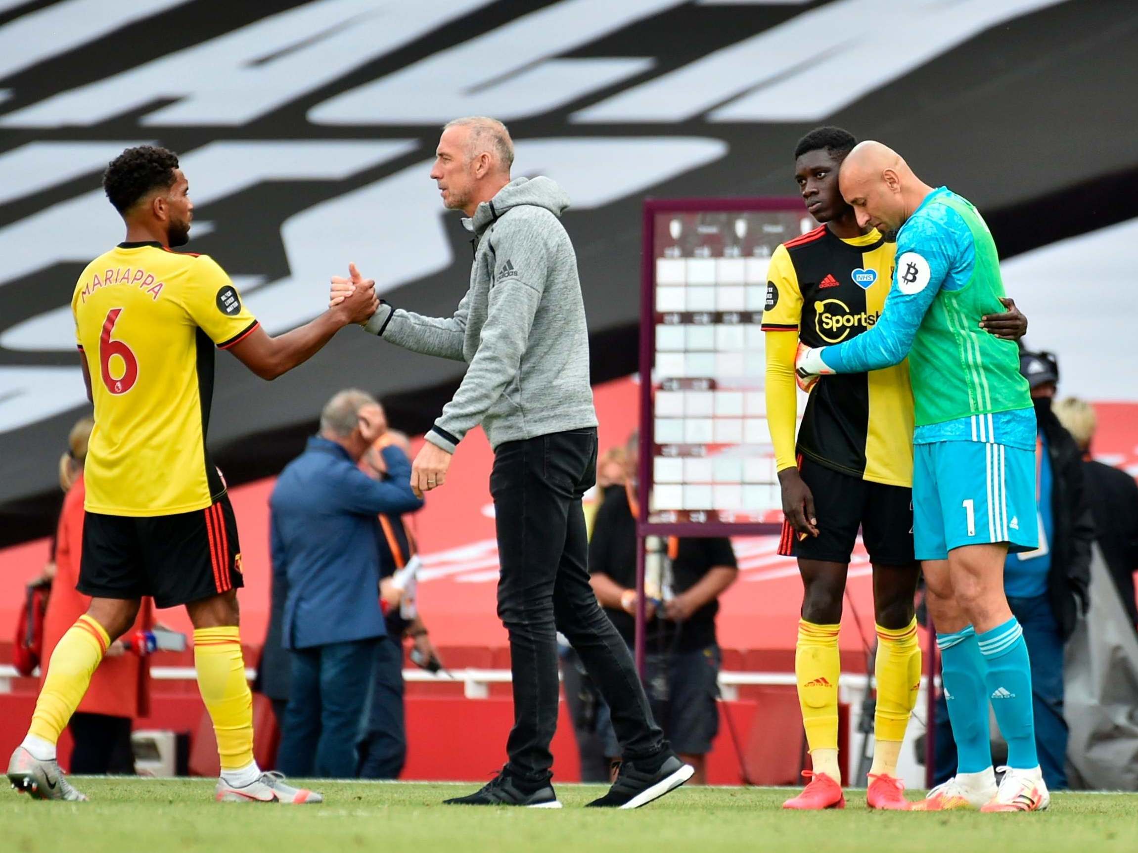 Watford players and staff console each other after relegation was confirmed