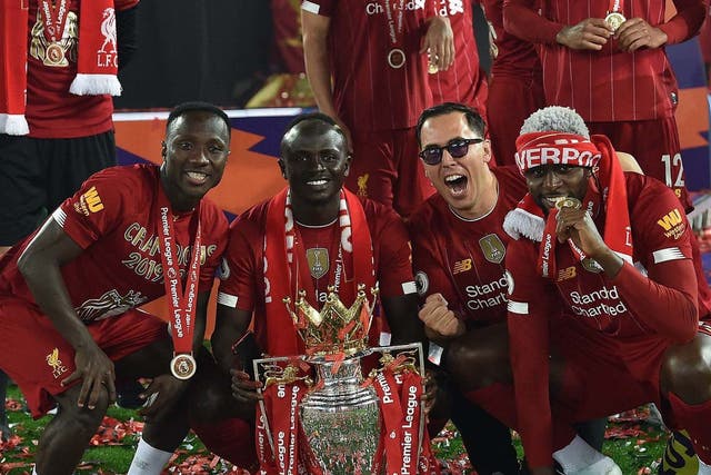 Liverpool players celebrate with the Premier League trophy