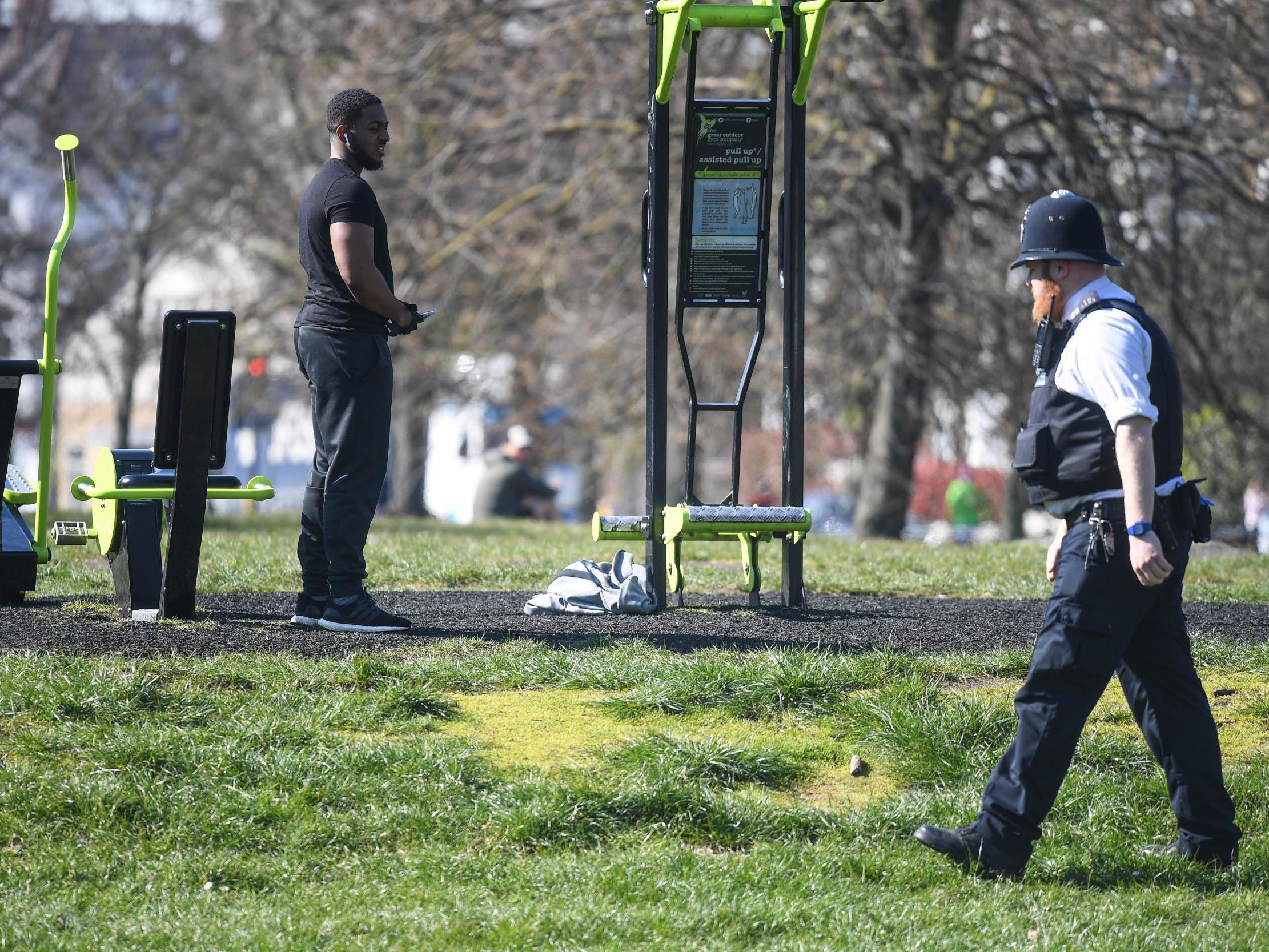 A police officer speaks to people on Clapham Common, south London, in March during the UK’s coronavirus lockdown