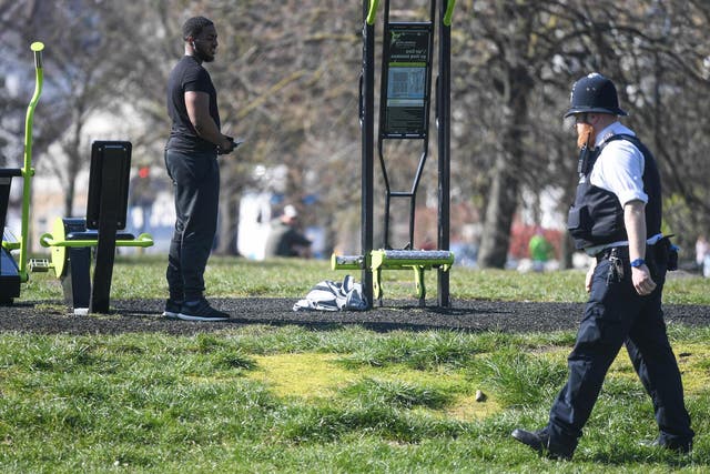 A police officer speaks to people on Clapham Common, south London, in March during the UK’s coronavirus lockdown