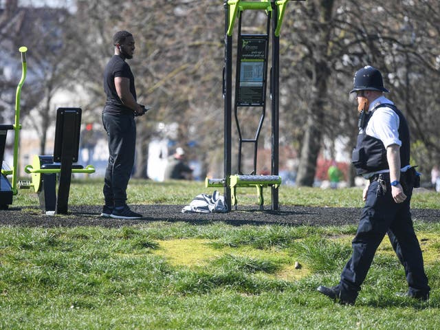 A police officer speaks to people on Clapham Common, south London, in March during the UK’s coronavirus lockdown