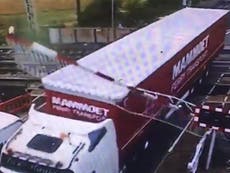 Lorry driver rams through level crossing barrier