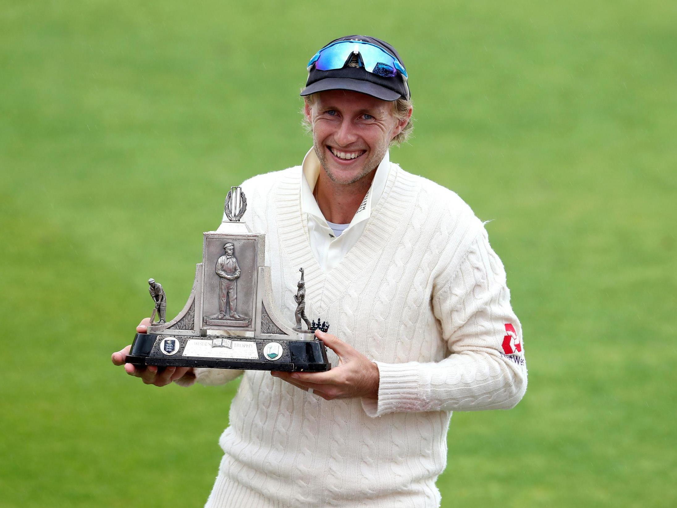 England's Joe Root celebrates their series victory with the Wisden Trophy