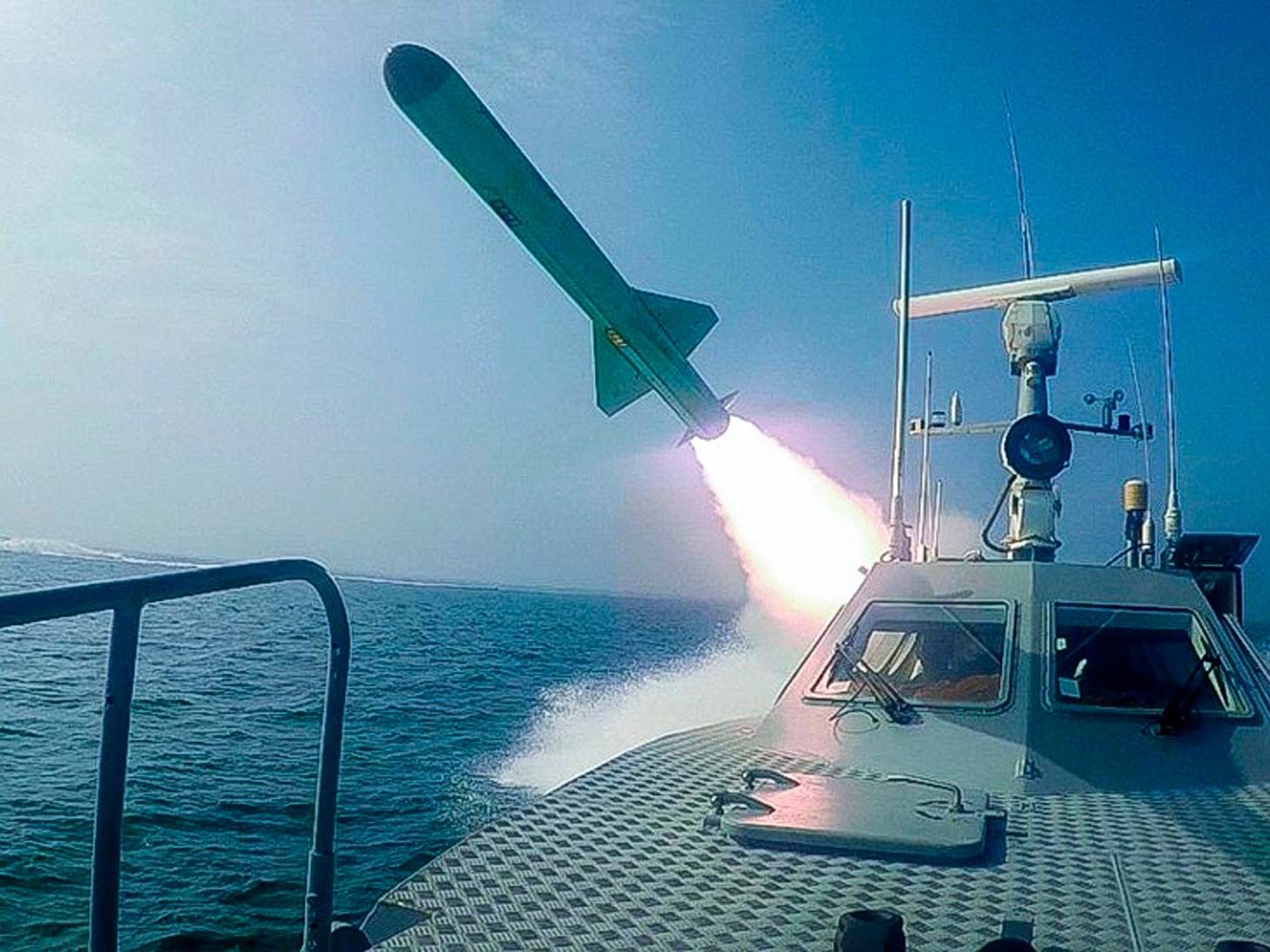 A Revolutionary Guard boat fires a missile during a military exercise on Tuesday