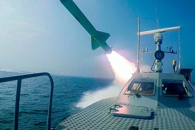 A Revolutionary Guard boat fires a missile during a military exercise on Tuesday
