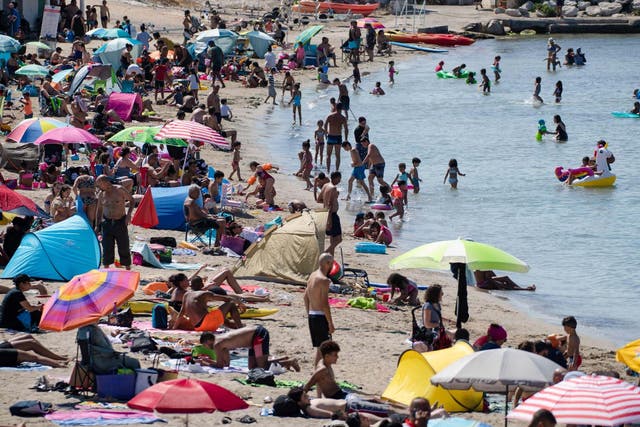 People enjoy the sea at the "Pointe Rouge" beach at the beginning of a heatwave in Marseille, southern France, 27 July 2020.