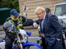 Boris Johnson elbow bumps police officer while not wearing mask