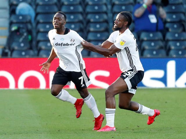 Fulham's Neeskens Kebano, left, celebrates scoring their first goal