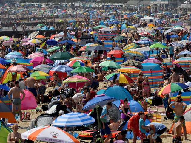 People bask in the sun at Bournemouth beach on 31 July, 2020, the warmest day of the year so far.