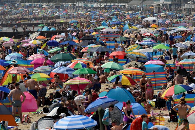 People bask in the sun at Bournemouth beach on 31 July, 2020, the warmest day of the year so far.
