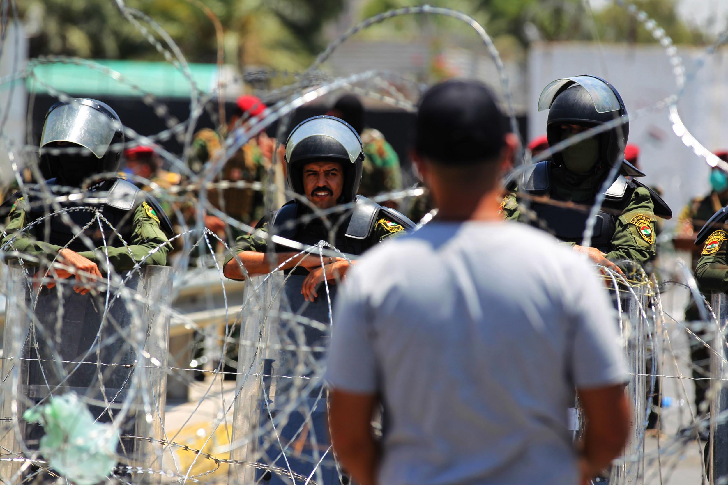 Iraqi security forces stand guard outside the entrance of the Green Zone during a protest in the capital Baghdad in July