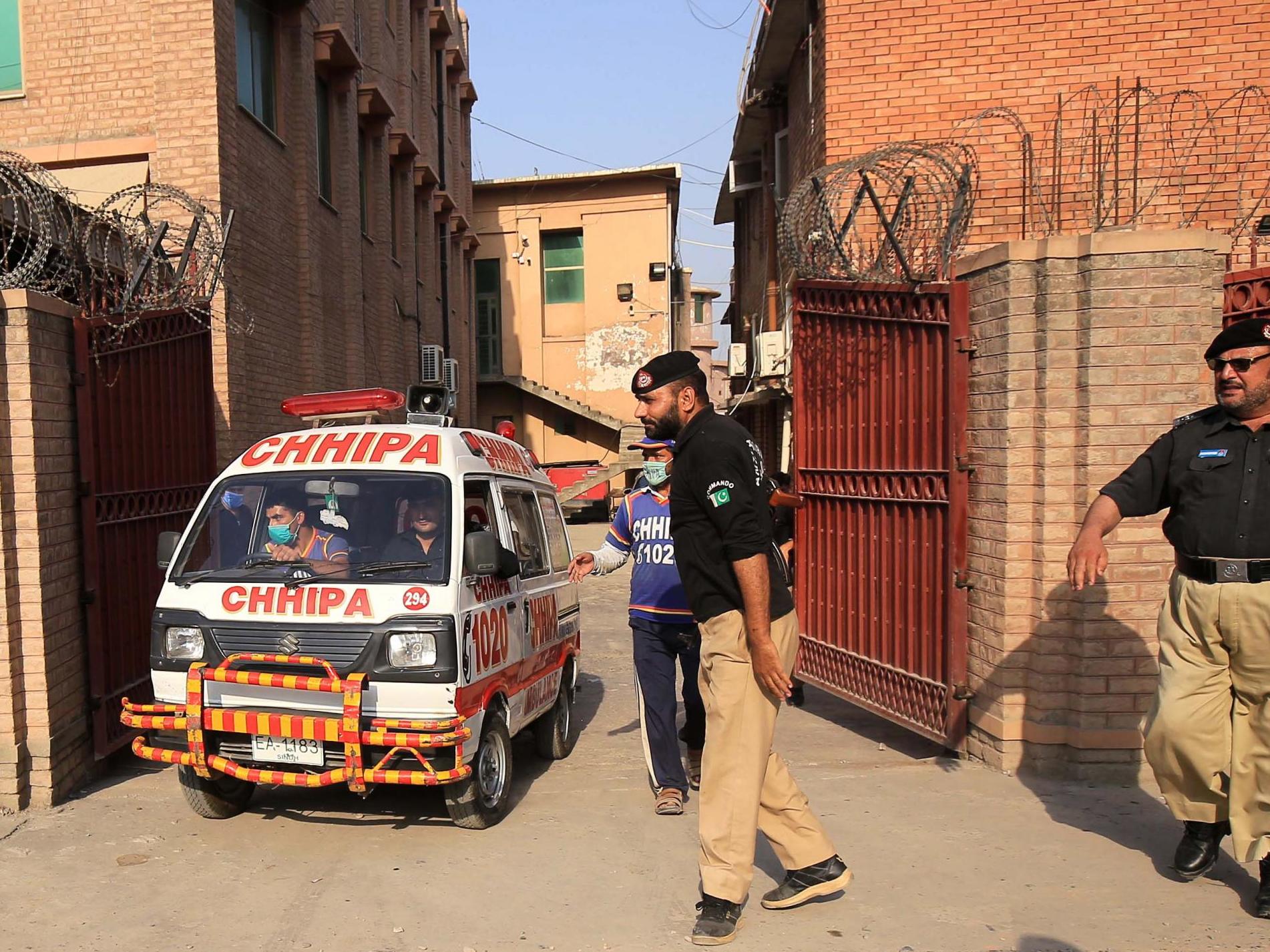 An ambulance car transports the body of Tahir Naseem, who was shot dead in a court room