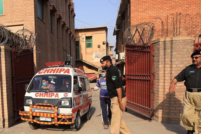 An ambulance car transports the body of Tahir Naseem, who was shot dead in a court room