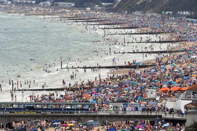 People enjoy the sunny weather at the Bournemouth Beach, amid the coronavirus disease (COVID-19) outbreak, in Bournemouth