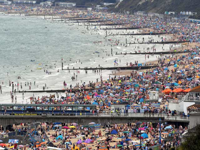 People enjoy the sunny weather at the Bournemouth Beach, amid the coronavirus disease (COVID-19) outbreak, in Bournemouth