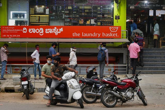 People line-up outside a Bangalore liquor store to make a last minute purchase ahead of a new lockdown