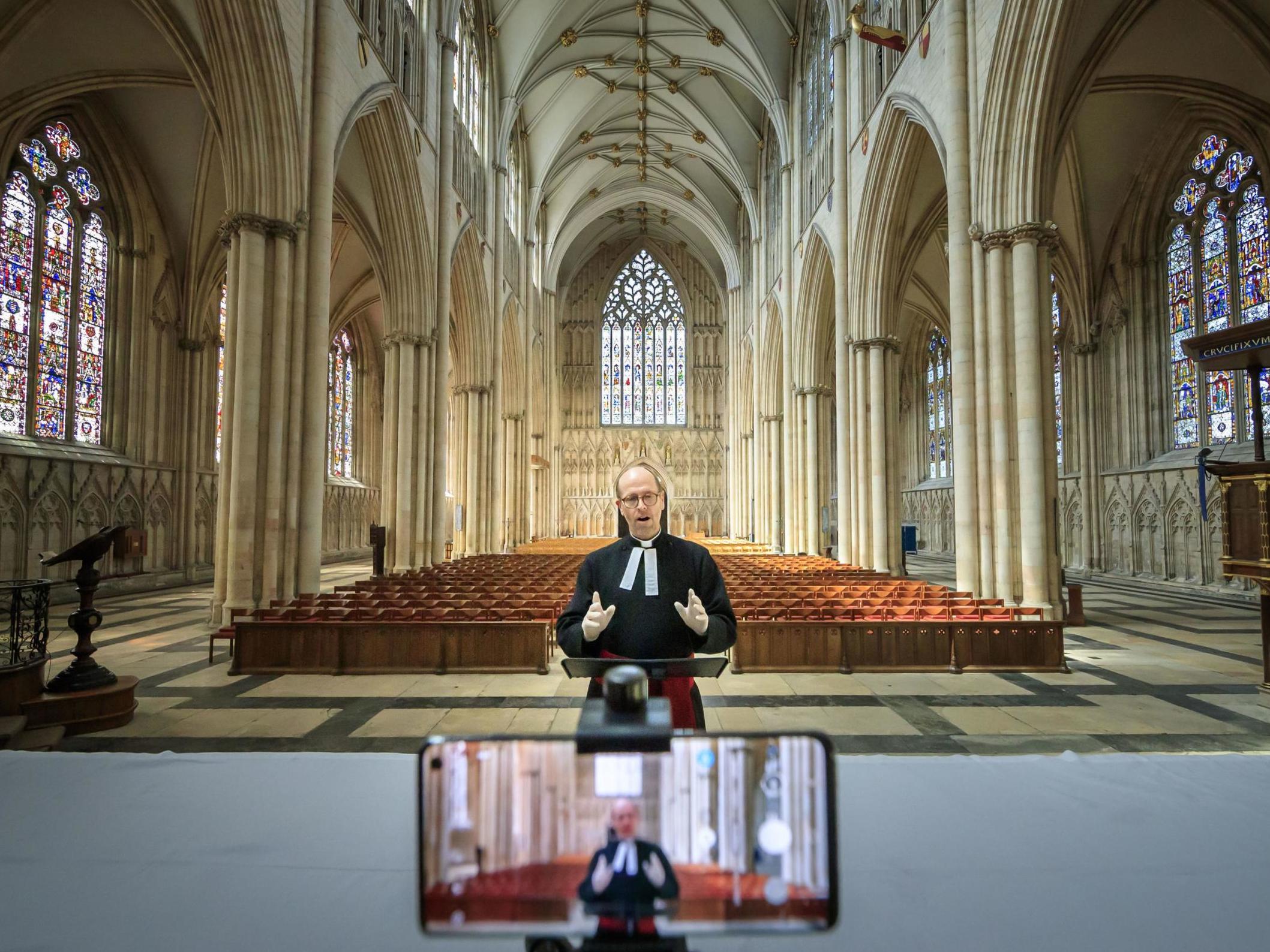 The Revd Michael Smith, York Minster's Canon Pastor, rehearses a digital Evensong service inside the cathedral, as the government moves towards the introduction of measures to bring the country out of lockdown