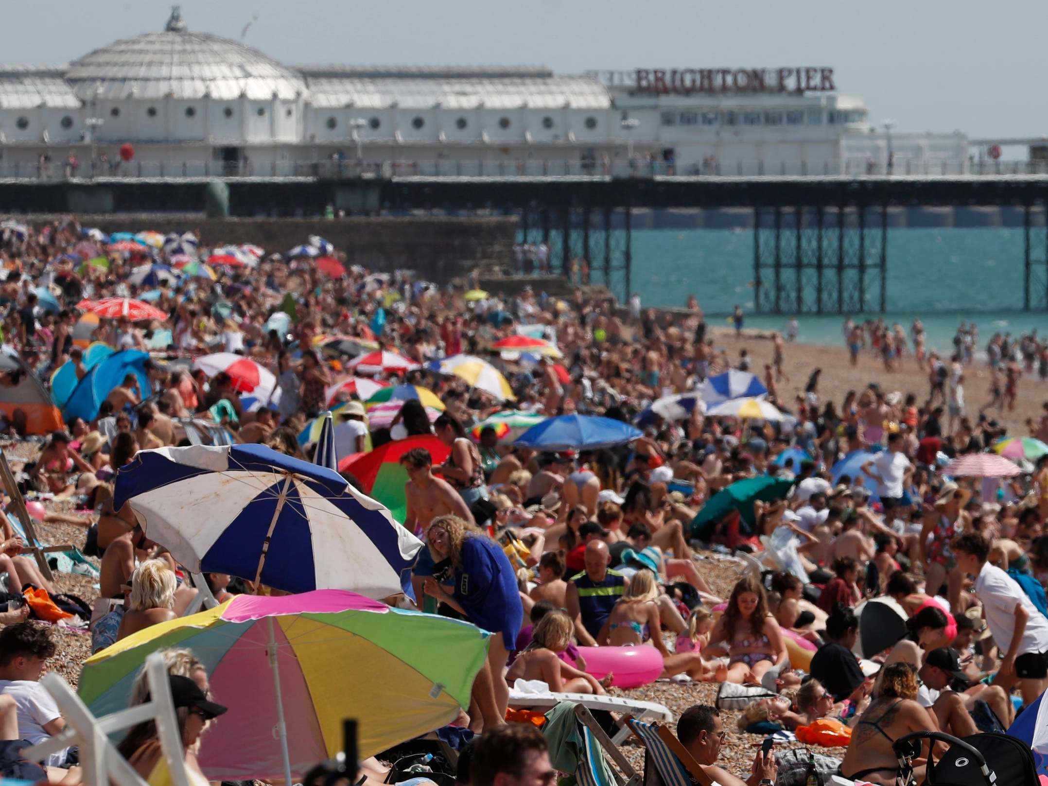 Beachgoers enjoy the sunshine and sea on what is now Britain's hottest day of the year so far, in Brighton, Friday 31 July