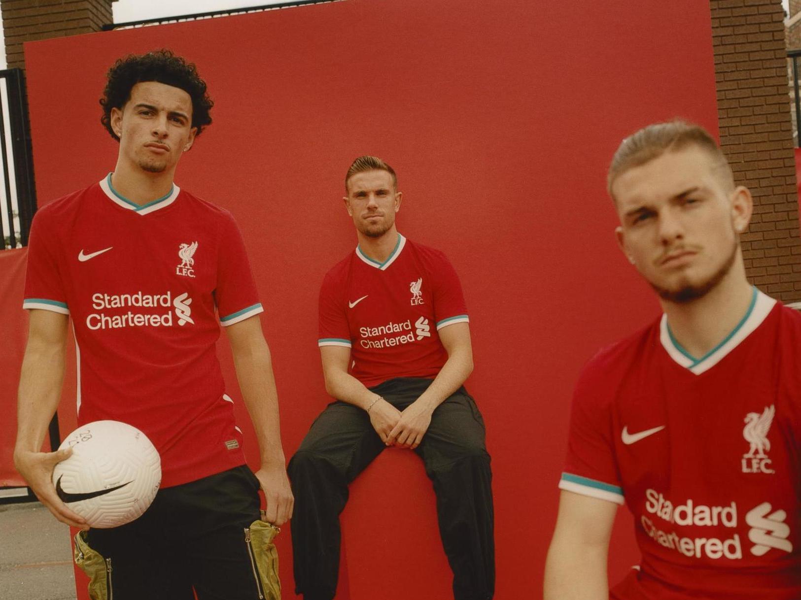 Liverpool players Curtis Jones, Jordan Henderson and Harvey Elliott model the new kit