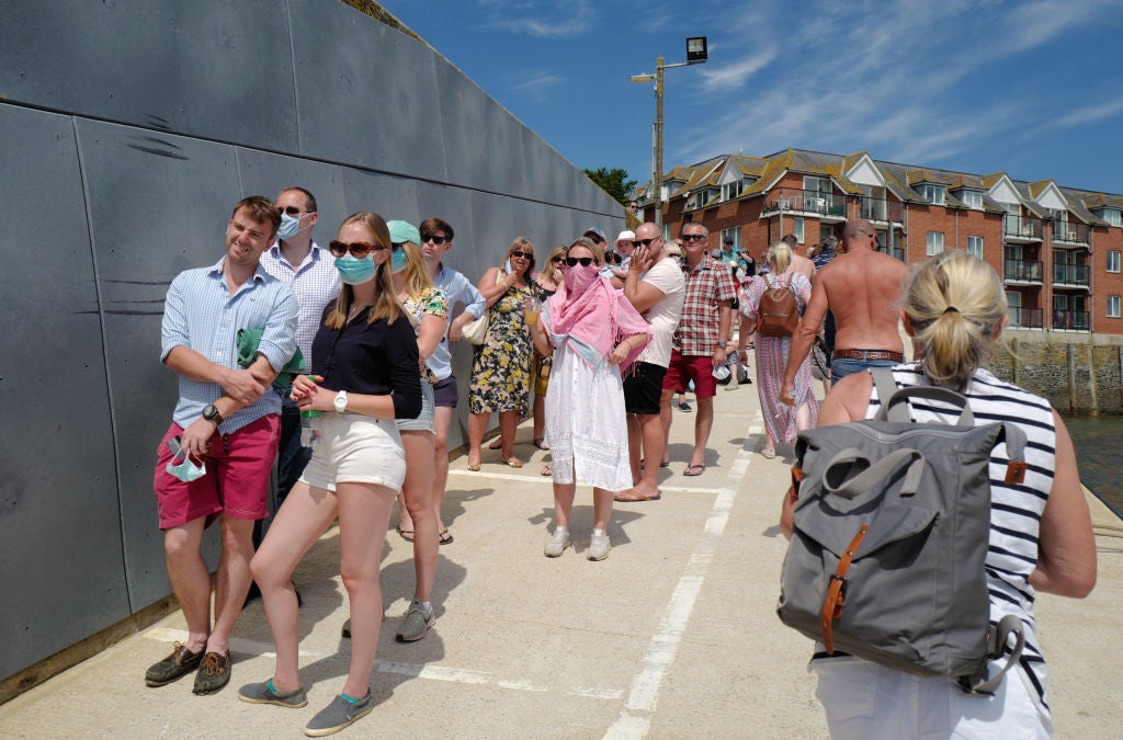 Holidaymakers queue for the Padstow-rock ferry (Getty)