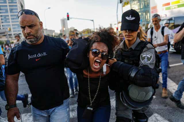 Israeli security forces detain a protester during demonstrations in Tel Aviv last year against police violence and the killing of a young Ethiopian man