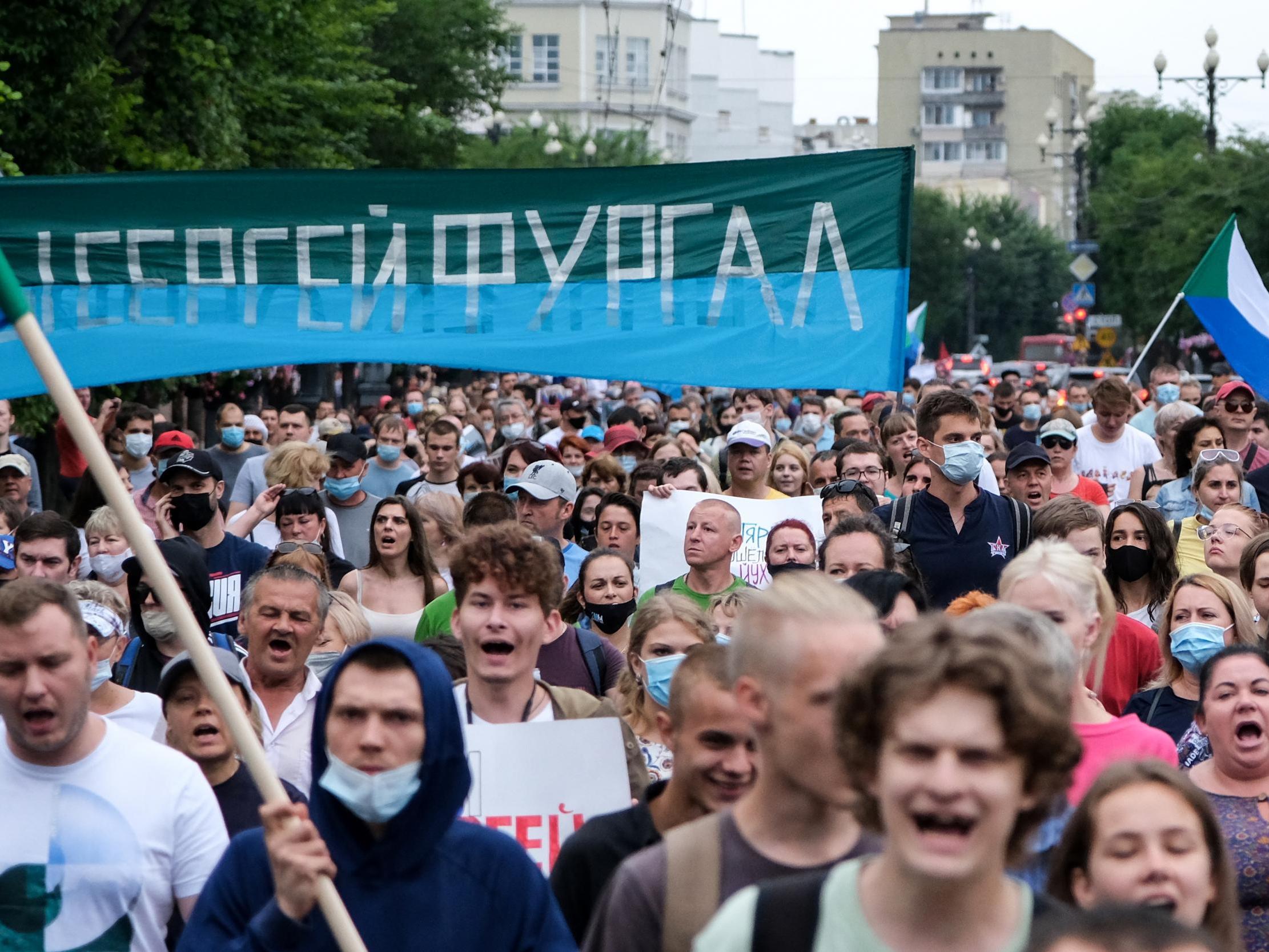 People carry a banner reading 'Sergei Furgal', during an unauthorised rally in support of Sergei Furgal in the Russian far eastern city of Khabarovsk