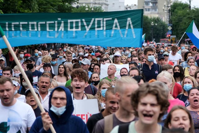 People carry a banner reading 'Sergei Furgal', during an unauthorised rally in support of Sergei Furgal in the Russian far eastern city of Khabarovsk
