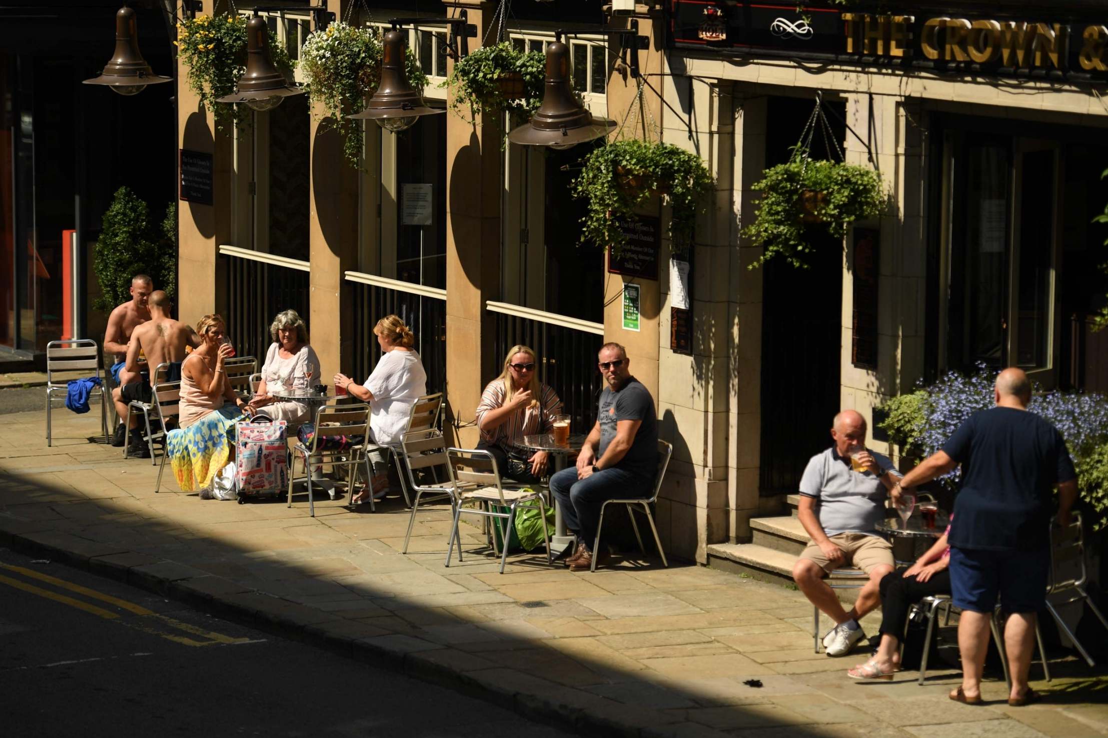 Manchester pub-goers enjoy a drink in the sun