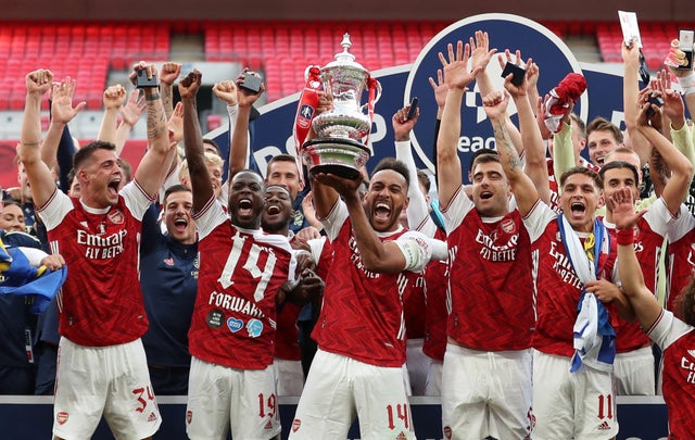 Arsenal's Pierre-Emerick Aubameyang celebrates with the trophy and teammates after winning the FA Cup, as play resumes behind closed doors following the outbreak of the coronavirus disease 