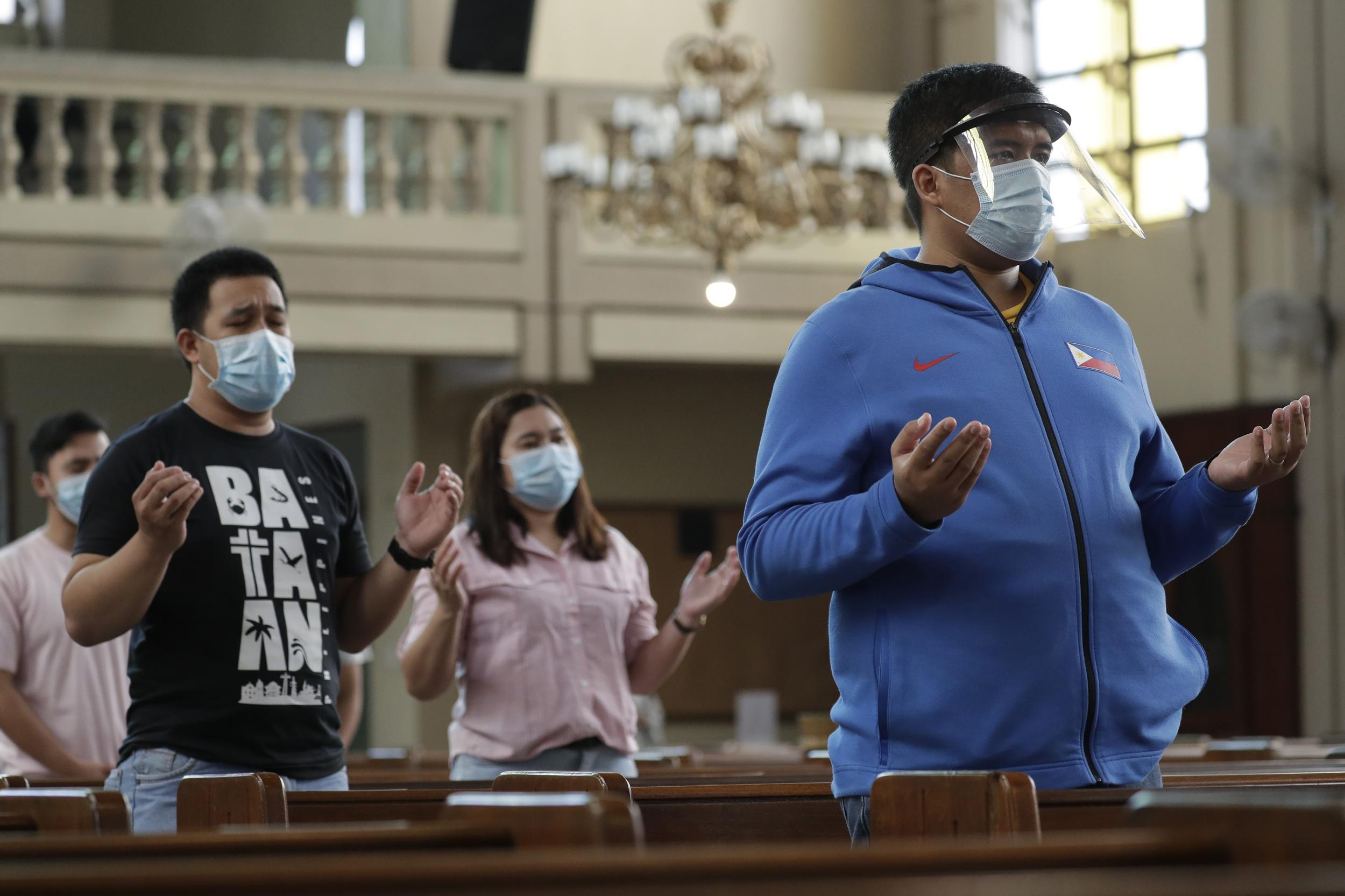 Parishioners wearing masks as a measure to prevent the spread of Covid-19 pray during a Mass at the Our Lady of Consolation Parish in the Philippines