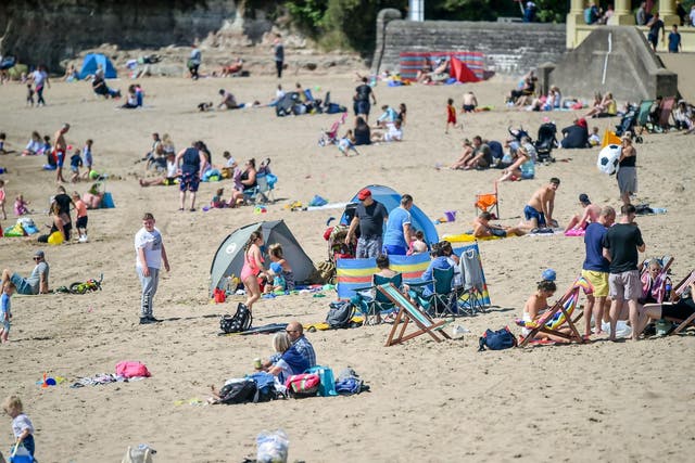 People enjoy the warm weather at Barry Island beach, Wales, on 2 August, 2020.