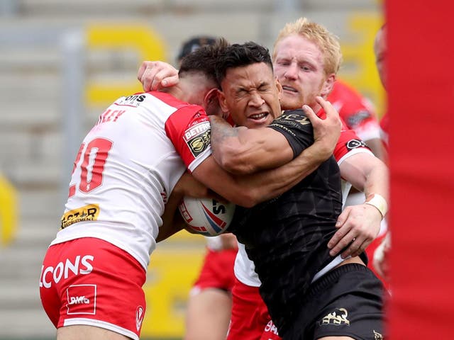 Catalan Dragons' Israel Folau is tackled by St Helens' James Bentley (left) and James Graham