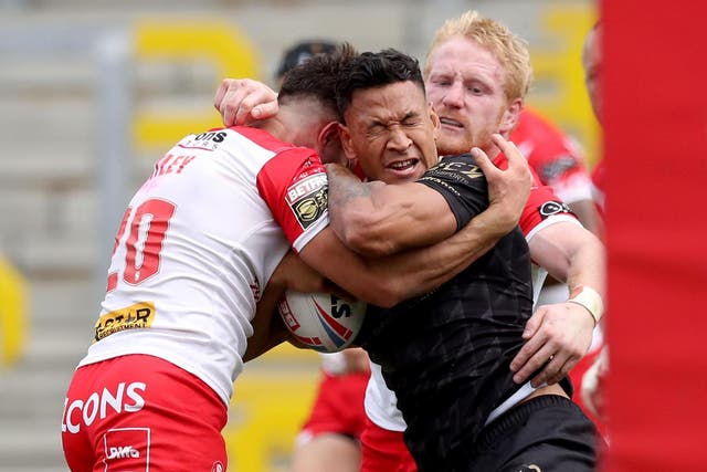 Catalan Dragons' Israel Folau is tackled by St Helens' James Bentley (left) and James Graham