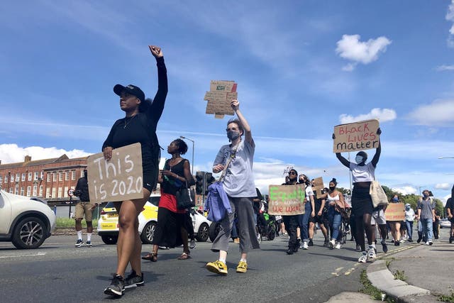 Protesters march down a street in Bristol on 2 August, 2020, after a racially-aggravated attack on a 21-year-old NHS worker in the city.
