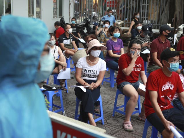 People wait in line for Covid-19 test in Hanoi, Vietnam after the country reported on Friday its first-ever death of someone caused by the virus