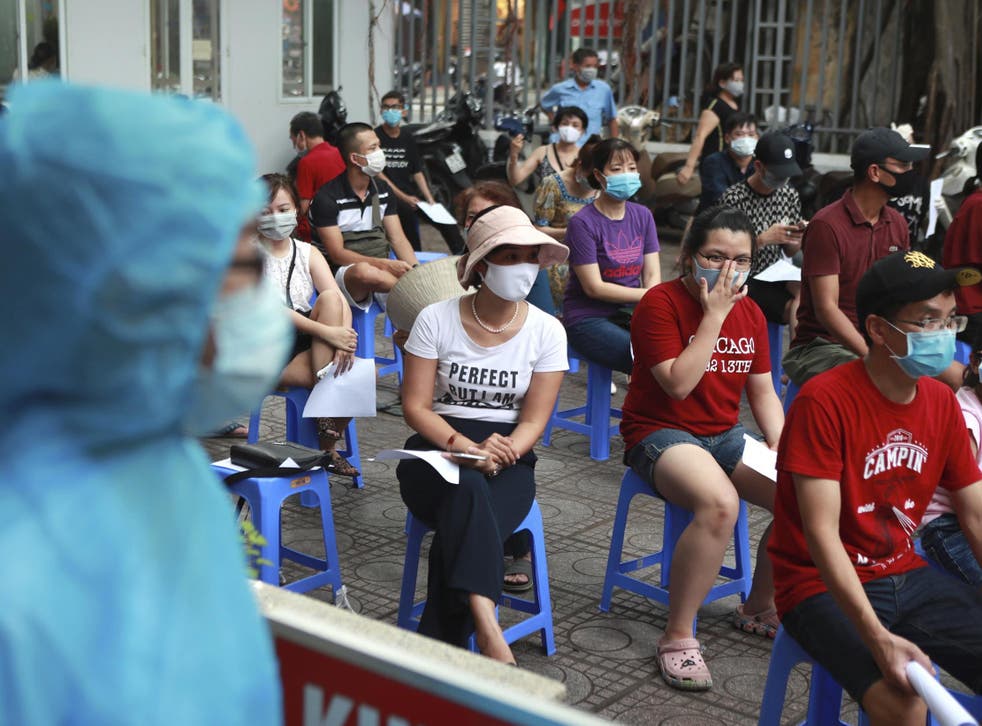 People wait in line for Covid-19 test in Hanoi, Vietnam after the country reported on Friday its first-ever death of someone caused by the virus