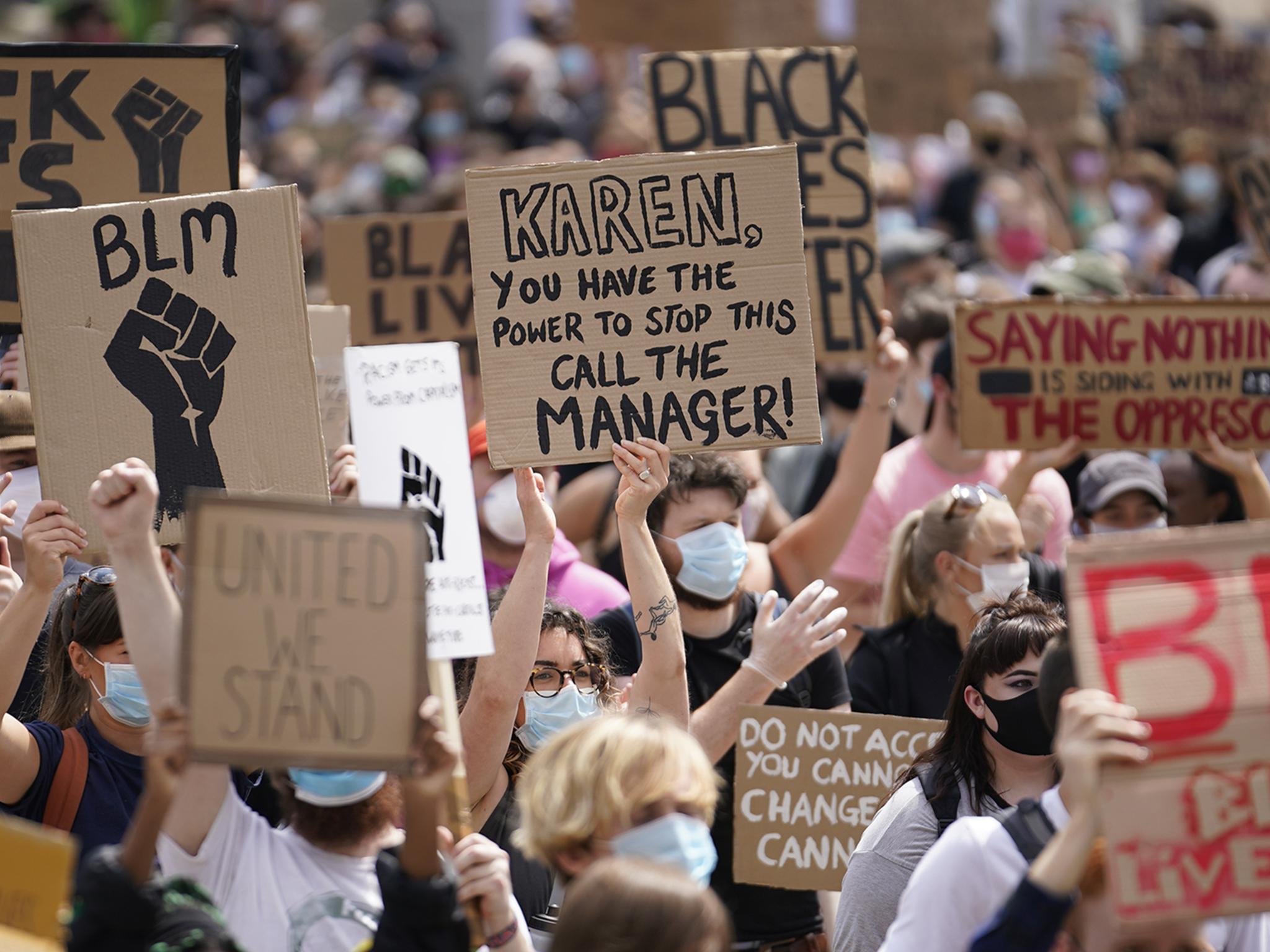 People hold placards during a Black Lives Matter rally in Leeds on 14 June