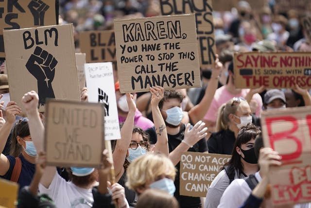 People hold placards during a Black Lives Matter rally in Leeds on 14 June