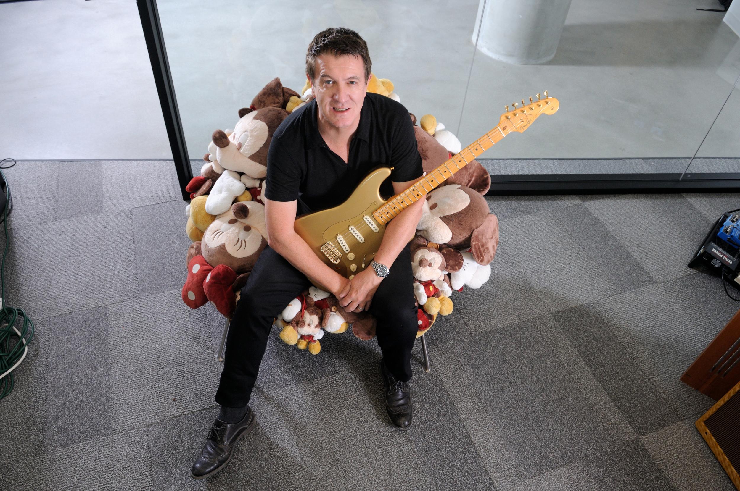 Mooney cradles a Stratocaster in his Los Angeles office