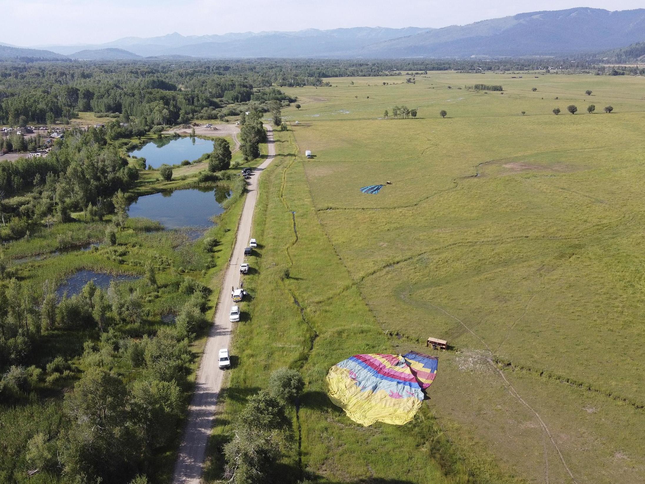 Two of three sightseeing balloons that crashed are seen in an open area of Jackson Hole in western Wyoming. Between 16 and 20 people were hurt, officials said
