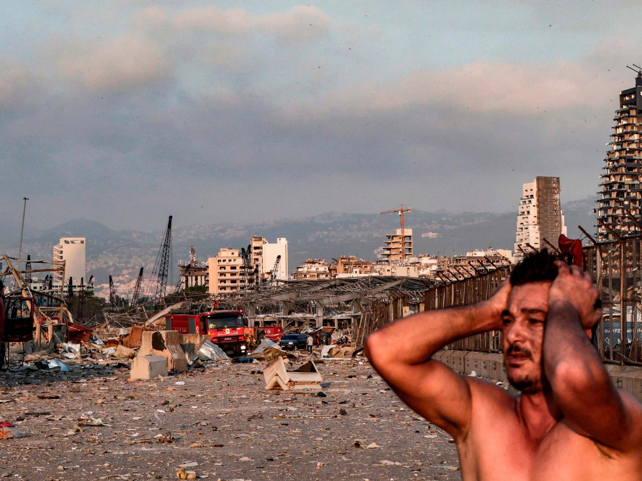 A man reacts at the scene of an explosion at the port in Lebanon's capital Beirut