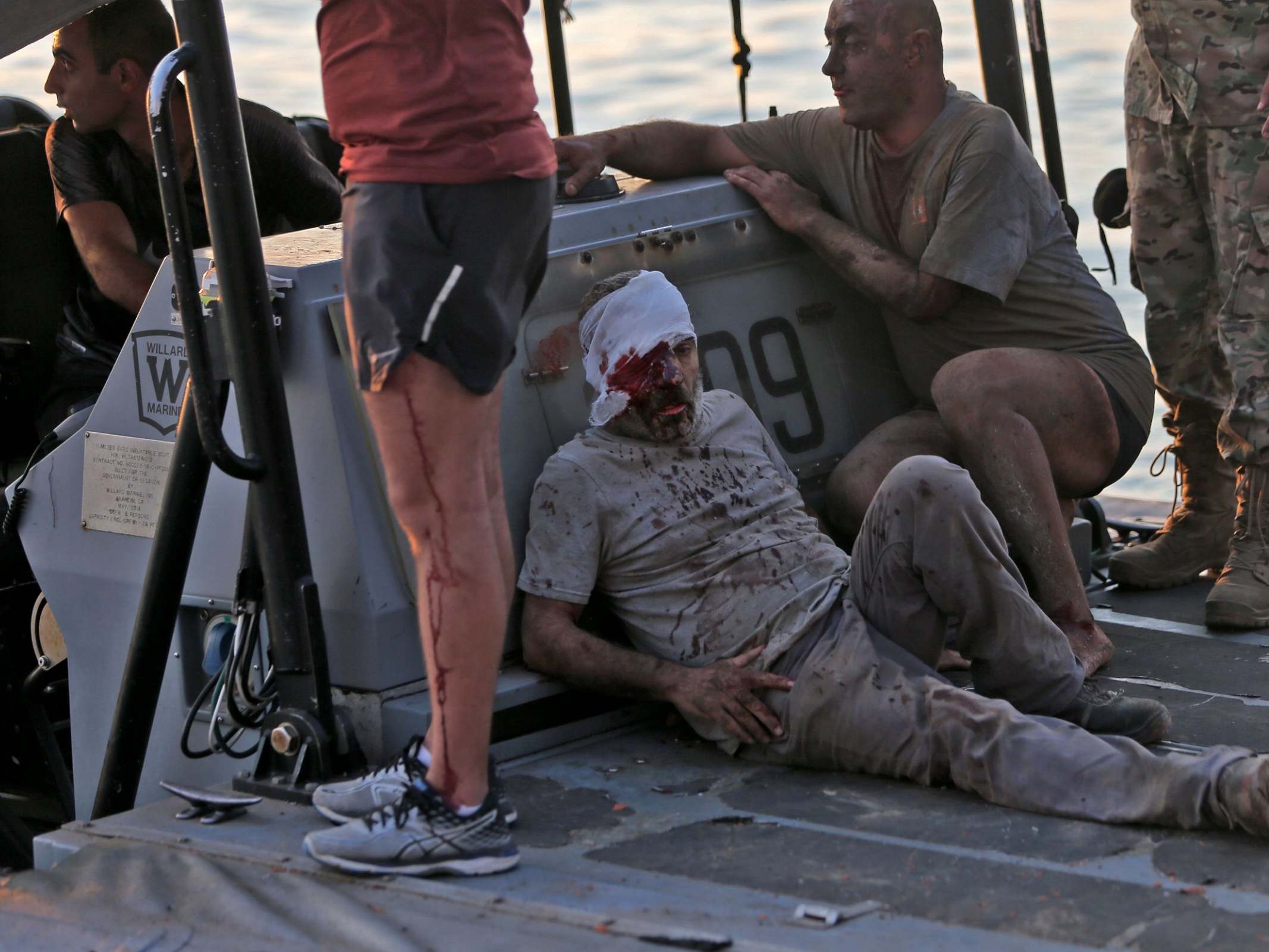 A wounded man is evacuated by boat after the explosion