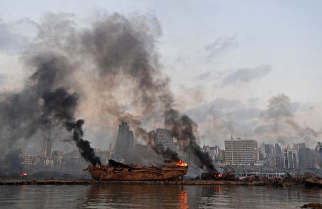 A ship in flames is pictured at the port of Beirut following a massive explosion on Tuesday