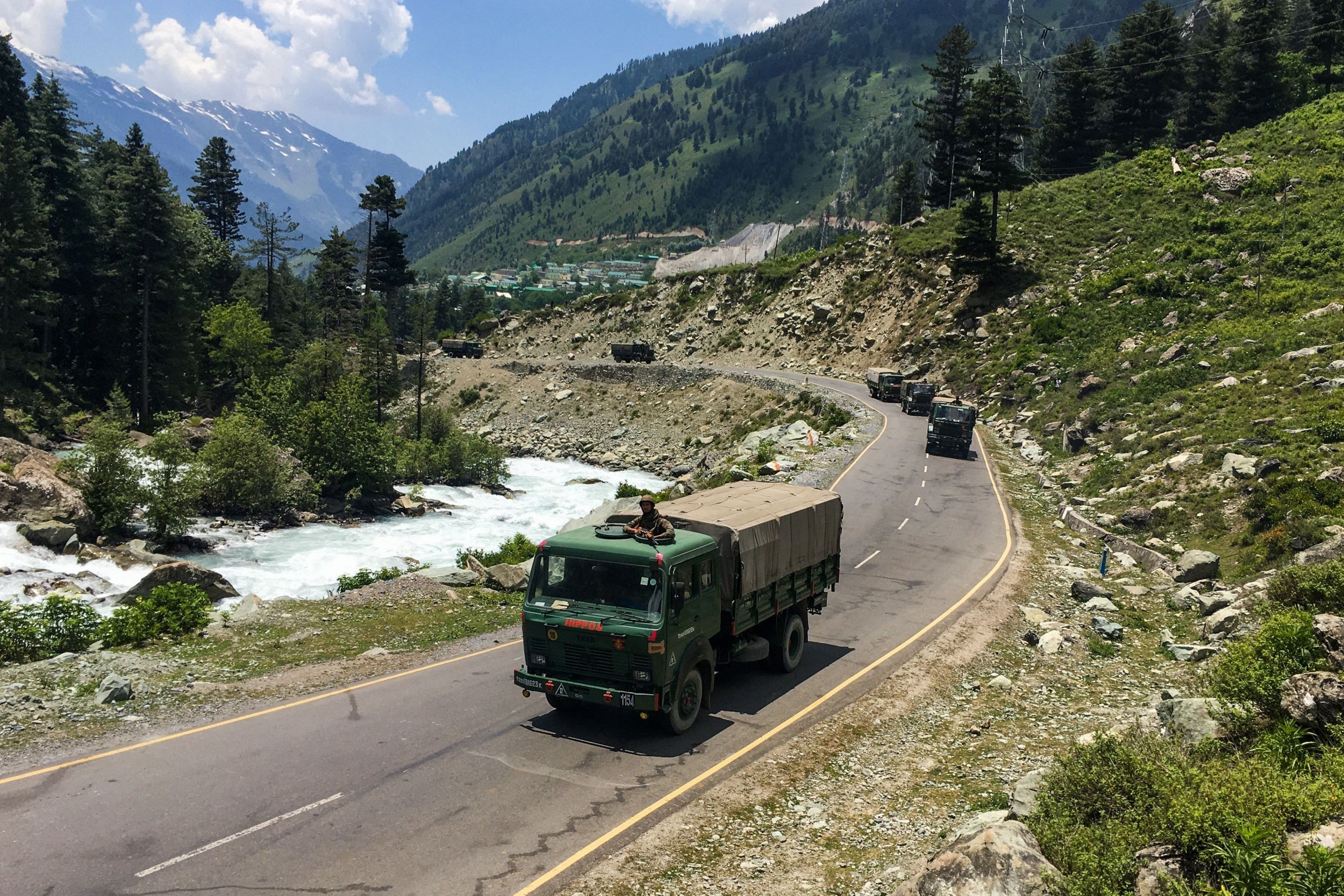 An Indian army convoy makes its way towards Leh, bordering China, in Gagangir. At least 20 Indian soldiers were killed in a ‘violent face-off’, the army said on 16 June (AFP/Getty)